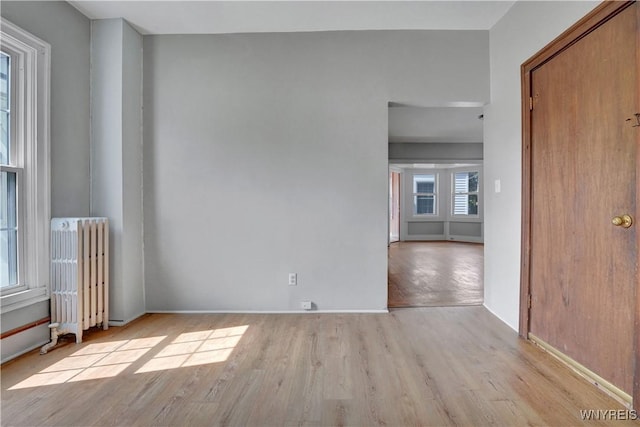 10470 Main St, North Collins, NY 14111 - empty room with radiator heating unit and wood finished floors