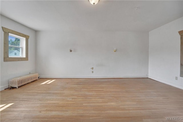 10470 Main St, North Collins, NY 14111 - spare room featuring radiator heating unit and light wood-style floors