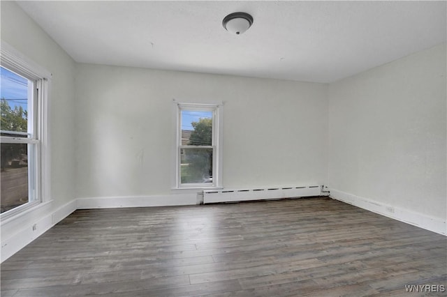 10470 Main St, North Collins, NY 14111 - empty room with a baseboard heating unit, healthy amount of natural light, and wood finished floors