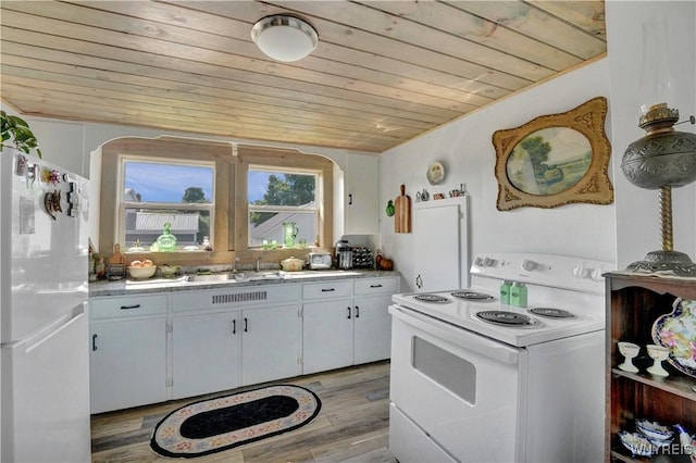 10470 Main St, North Collins, NY 14111 - kitchen with white appliances, wood ceiling, light countertops, and light wood finished floors