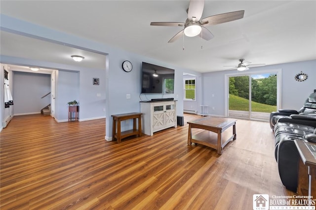 2777 S Roberts Rd, Sheridan, NY 14063 - living area featuring stairs, a ceiling fan, wood finished floors, and baseboard heating