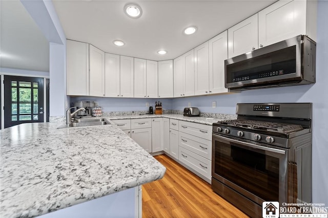 2777 S Roberts Rd, Sheridan, NY 14063 - kitchen with stainless steel appliances, white cabinetry, recessed lighting, light wood-style floors, and light stone countertops
