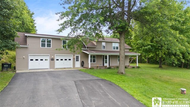 2777 S Roberts Rd, Sheridan, NY 14063 - traditional home featuring a porch, driveway, a front yard, and an attached garage