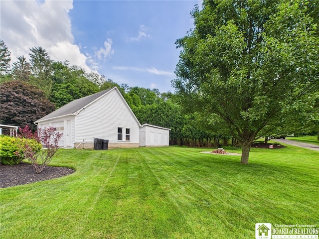 118 N 3rd St, Allegany, NY 14706 - view of grassy yard with a garage and an outdoor structure