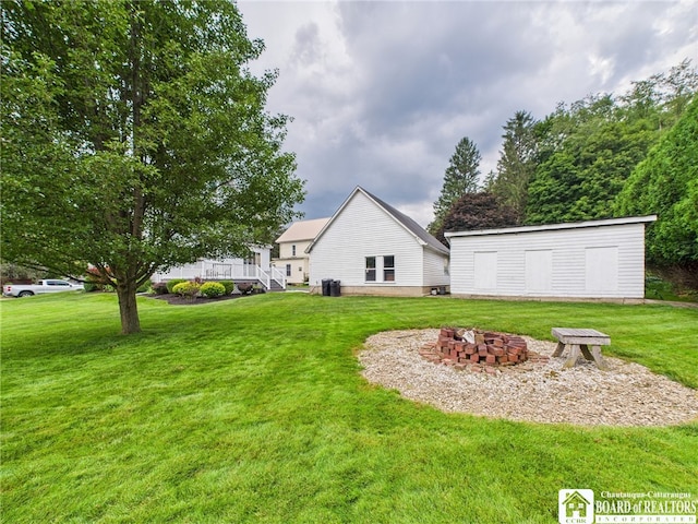 118 N 3rd St, Allegany, NY 14706 - view of green lawn with an outdoor fire pit and an outdoor structure