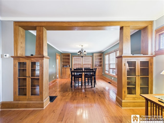 118 N 3rd St, Allegany, NY 14706 - dining area with wood-type flooring, a chandelier, and ornamental molding
