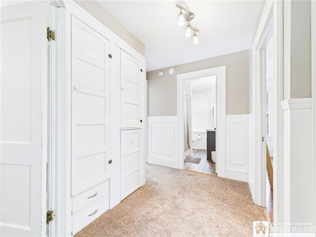 118 N 3rd St, Allegany, NY 14706 - corridor with carpet, wainscoting, and a decorative wall