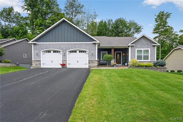 8873 Salvatore Ave, Lysander, NY 13027 - view of front of home with an attached garage, stone siding, driveway, board and batten siding, and a front yard