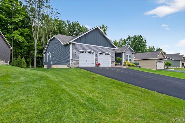 8873 Salvatore Ave, Lysander, NY 13027 - view of front facade featuring a garage, asphalt driveway, board and batten siding, a front yard, and stone siding