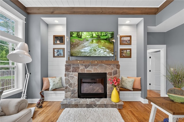 8873 Salvatore Ave, Lysander, NY 13027 - living area with wood finished floors, a fireplace, crown molding, and a wood ceiling with exposed beams