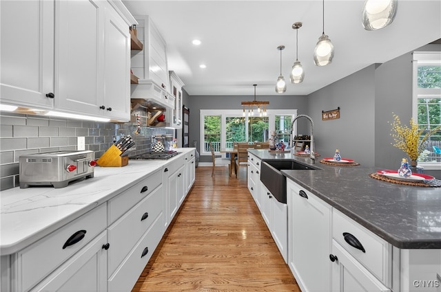 8873 Salvatore Ave, Lysander, NY 13027 - kitchen with light wood-style floors, white cabinets, backsplash, recessed lighting, and pendant lighting