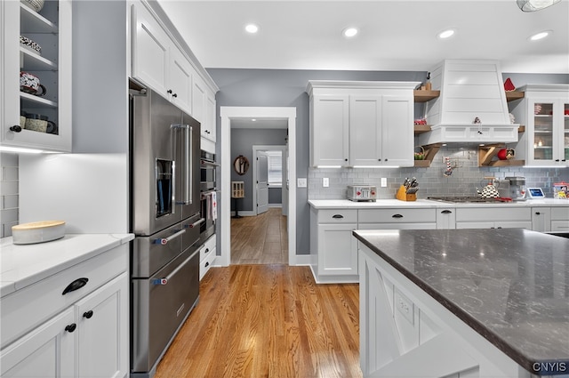 8873 Salvatore Ave, Lysander, NY 13027 - kitchen with appliances with stainless steel finishes, custom range hood, light wood-style floors, white cabinets, and recessed lighting