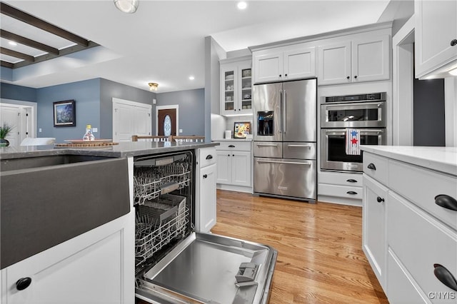 8873 Salvatore Ave, Lysander, NY 13027 - kitchen with stainless steel appliances, recessed lighting, glass insert cabinets, white cabinetry, and light wood finished floors
