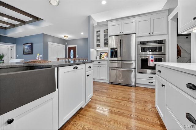 8873 Salvatore Ave, Lysander, NY 13027 - kitchen featuring appliances with stainless steel finishes, recessed lighting, glass insert cabinets, light wood-style floors, and white cabinets