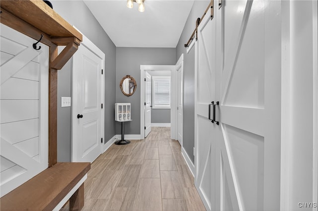 8873 Salvatore Ave, Lysander, NY 13027 - mudroom with a barn door and baseboards