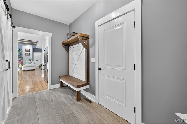 8873 Salvatore Ave, Lysander, NY 13027 - mudroom featuring a barn door and baseboards