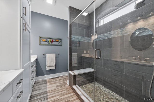 8873 Salvatore Ave, Lysander, NY 13027 - bathroom with vanity, a stall shower, and wood finished floors