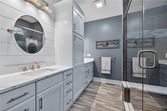 8873 Salvatore Ave, Lysander, NY 13027 - bathroom featuring vanity, a stall shower, and wood finished floors