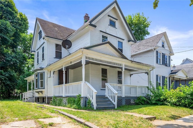 9 Englert St, Rochester, NY 14605 - victorian-style house featuring a chimney, covered porch, and a front yard