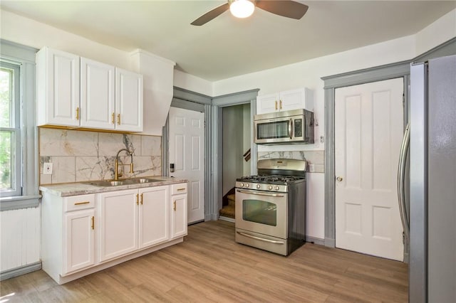 9 Englert St, Rochester, NY 14605 - kitchen featuring appliances with stainless steel finishes, white cabinets, plenty of natural light, and a ceiling fan