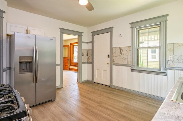 9 Englert St, Rochester, NY 14605 - kitchen with stainless steel fridge, ceiling fan, light wood-style floors, wainscoting, and light countertops