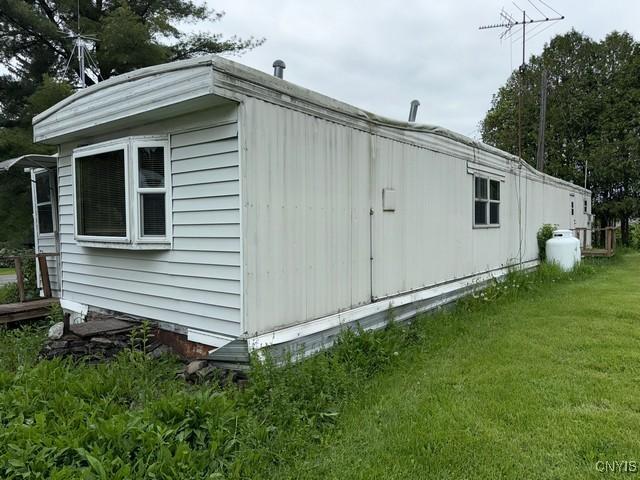 6792 Creek Rd, Lincoln, NY 13421 - view of side of property featuring a yard