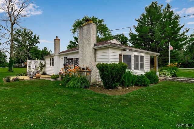 2610 Coomer Rd, Newfane, NY 14028 - view of home's exterior featuring a lawn and a chimney
