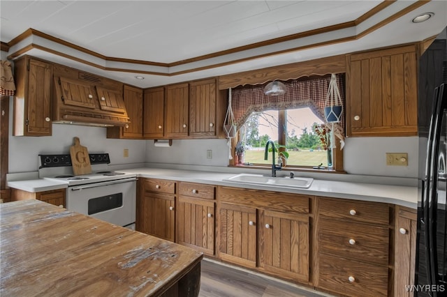 2610 Coomer Rd, Newfane, NY 14028 - kitchen featuring white electric stove, custom range hood, brown cabinets, black fridge, and light countertops