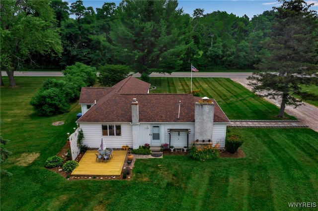 2610 Coomer Rd, Newfane, NY 14028 - rear view of property with a chimney, a wooden deck, and a lawn