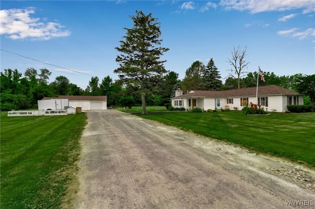 2610 Coomer Rd, Newfane, NY 14028 - ranch-style house featuring an outdoor structure, driveway, a front yard, and a detached garage