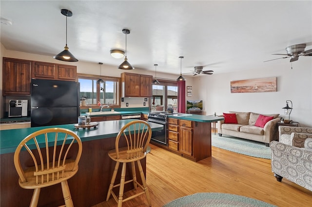 5041 Mapes Mathews Rd, Hector, NY 14818 - kitchen featuring freestanding refrigerator, range with electric cooktop, ceiling fan, a peninsula, and open floor plan