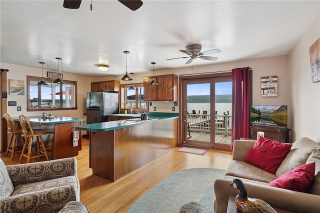 5041 Mapes Mathews Rd, Hector, NY 14818 - kitchen featuring ceiling fan, freestanding refrigerator, a peninsula, a kitchen bar, and open floor plan