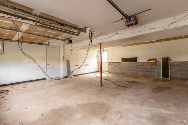 8405 Winterberry Way, Clay, NY 13090 - garage featuring a garage door opener and concrete block wall