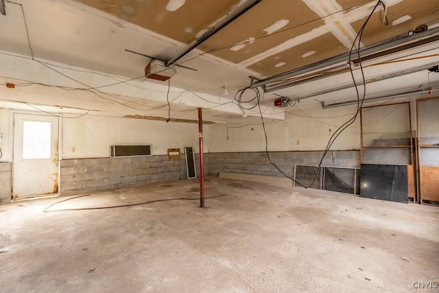 8405 Winterberry Way, Clay, NY 13090 - garage featuring a garage door opener and concrete block wall