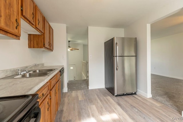 8405 Winterberry Way, Clay, NY 13090 - kitchen featuring freestanding refrigerator, brown cabinetry, black electric range, light countertops, and a ceiling fan
