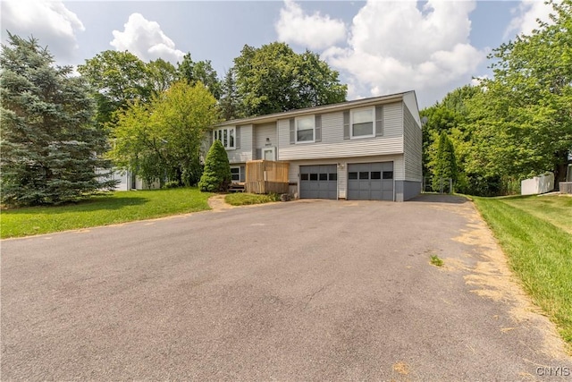 8405 Winterberry Way, Clay, NY 13090 - bi-level home with driveway, an attached garage, and a front yard