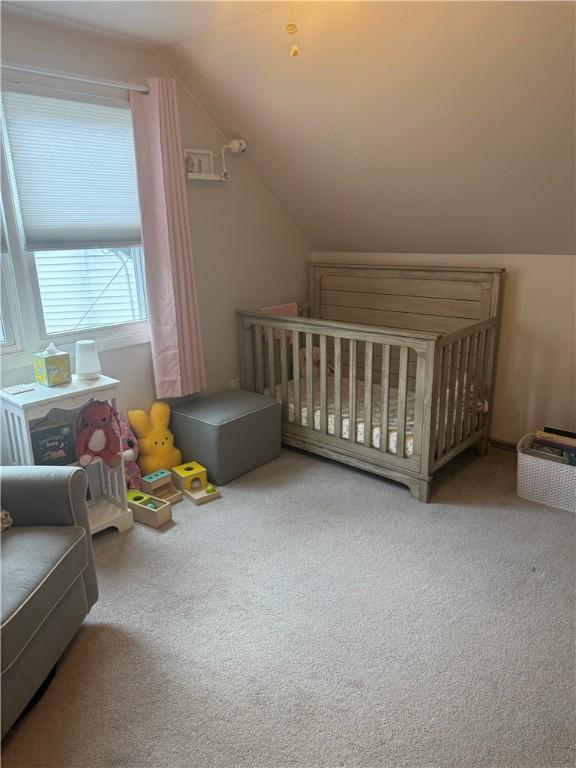 82 Winsor Cir, Elmira, NY 14905 - carpeted bedroom featuring vaulted ceiling and a nursery area