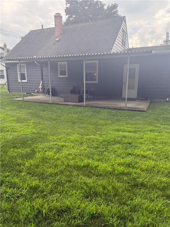 82 Winsor Cir, Elmira, NY 14905 - back of house with a patio, a yard, and a chimney