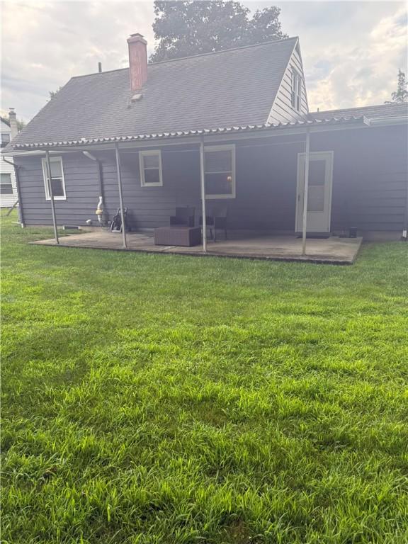 82 Winsor Cir, Elmira, NY 14905 - rear view of property with a patio area, a yard, and a chimney
