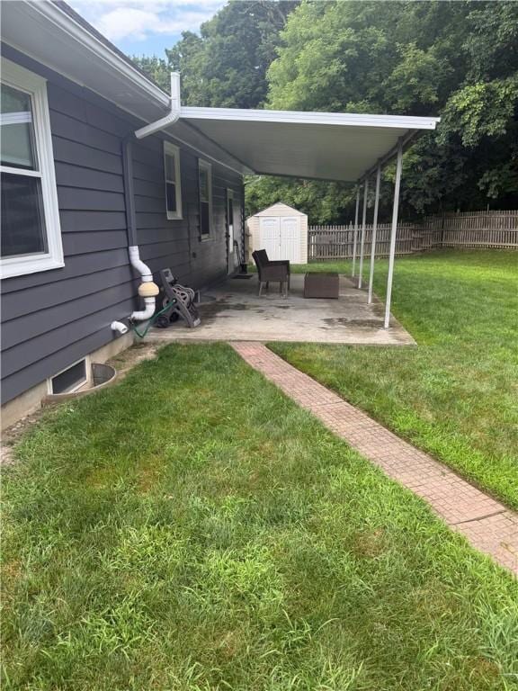 82 Winsor Cir, Elmira, NY 14905 - view of yard with a storage unit, a patio area, and a carport