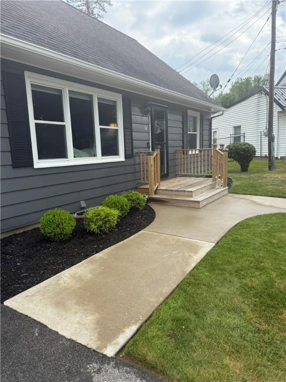 82 Winsor Cir, Elmira, NY 14905 - property entrance featuring a yard and a shingled roof