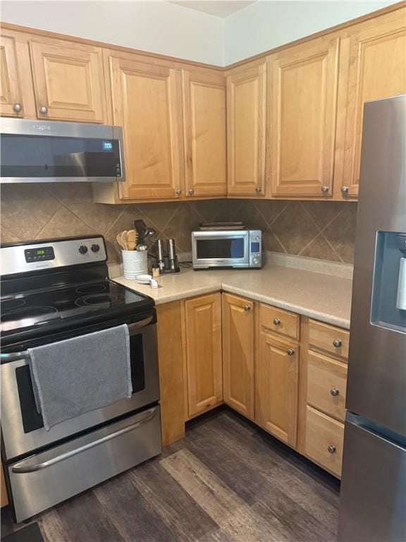 82 Winsor Cir, Elmira, NY 14905 - kitchen featuring appliances with stainless steel finishes, light countertops, dark wood finished floors, and backsplash