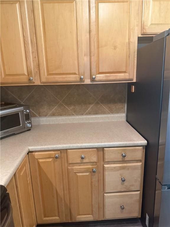 82 Winsor Cir, Elmira, NY 14905 - kitchen featuring stainless steel appliances, light countertops, decorative backsplash, and light brown cabinetry