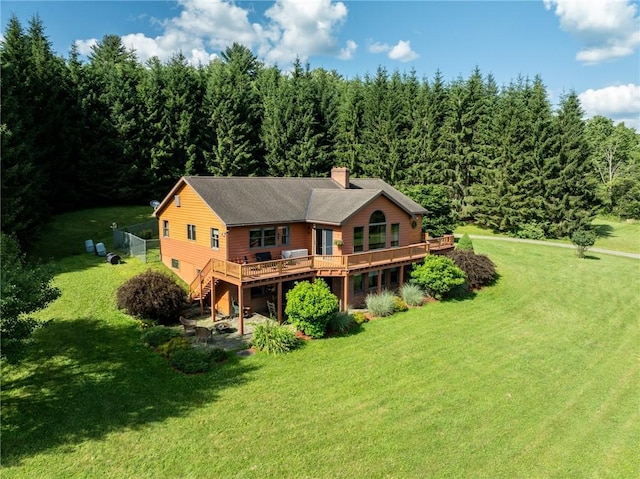 155 Hall Rd, Afton, NY 13730 - back of property featuring a deck, a forest view, a chimney, and a yard