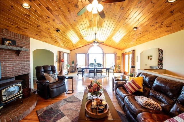 155 Hall Rd, Afton, NY 13730 - living area with vaulted ceiling, a ceiling fan, a wood stove, wood finished floors, and wood ceiling