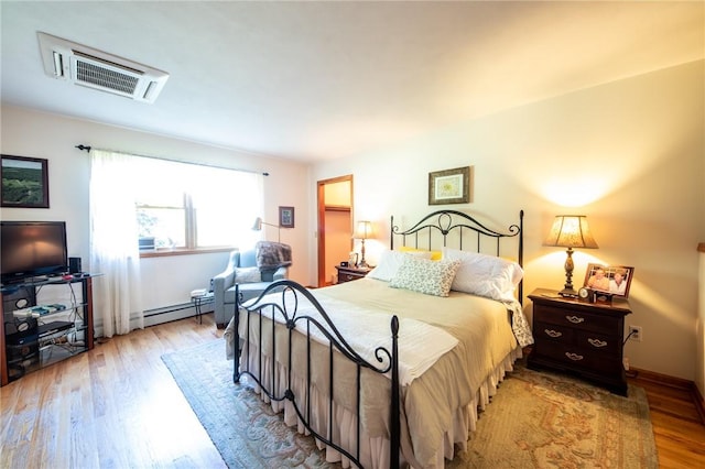 155 Hall Rd, Afton, NY 13730 - bedroom with baseboard heating and wood finished floors