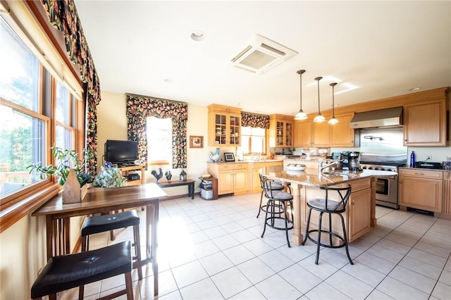 155 Hall Rd, Afton, NY 13730 - kitchen featuring wall chimney range hood, a kitchen breakfast bar, high end range, glass insert cabinets, and a center island