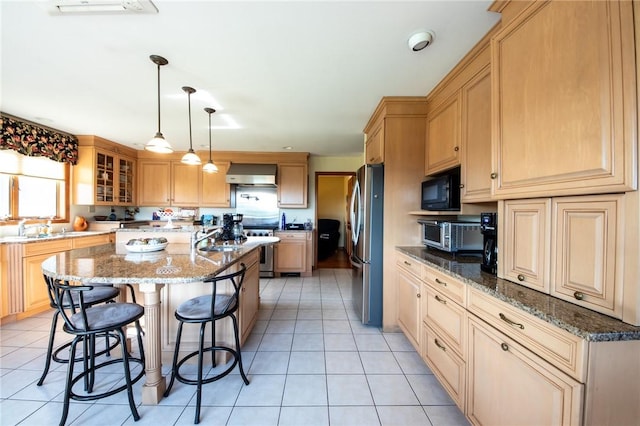 155 Hall Rd, Afton, NY 13730 - kitchen with stainless steel appliances, wall chimney range hood, a breakfast bar, a kitchen island, and light tile patterned flooring