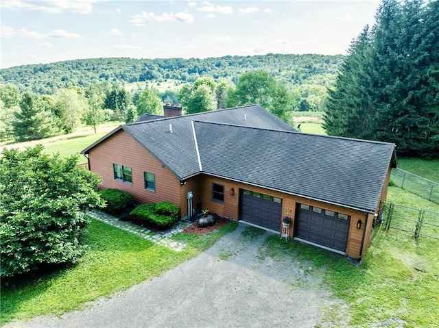 155 Hall Rd, Afton, NY 13730 - view of front facade featuring driveway, a garage, a chimney, a shingled roof, and a wooded view