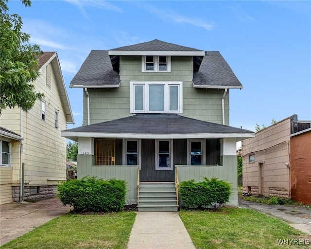 1143 Kensington Ave, Buffalo, NY 14215 - american foursquare style home with a porch, a shingled roof, and a front yard
